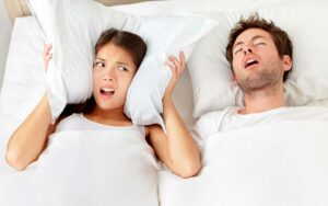 Man Snoring at Night Needs MARPE Snoring Solution from Hillsboro Dental Excellence
