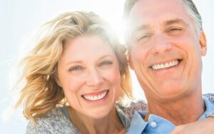 Smiling Couple with Fixed Implant Bridges from Hillsboro Dental Excellence