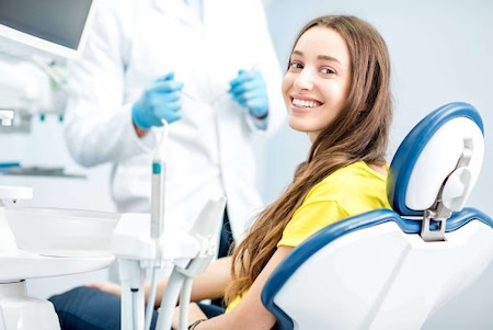 A happy female patient getting ready for a dental checkup.