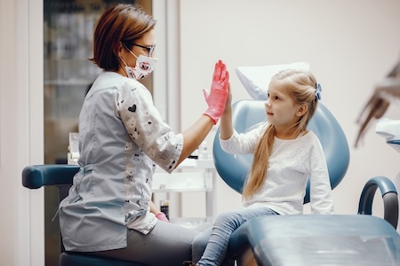 A dentist at his dental clinic examining an adorable little kid.
Highly Experienced Dentist Near You in Hillsboro!