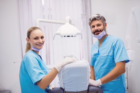 Dentist getting ready for dental bonding and white tooth fillings at the dentist's office.