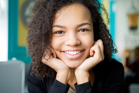 A closeup view of a girl after getting dental bonding and white tooth filling.