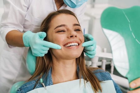 A happy, smiling girl at Hillsboro General Dentistry after getting an oral hygiene examination.