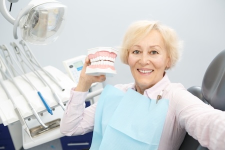 A senior patient at teh dentist’s office after getting gum disease treatment