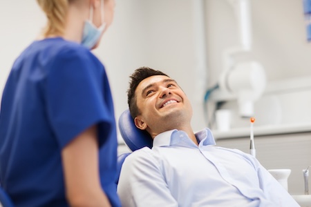 A male consulting with his female oral surgeon for oral and maxillofacial surgery.
