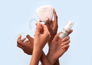 Dental aligner and whitening products in hands