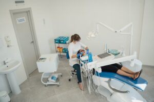 Dentist treating patient in modern clinic