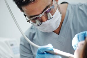 Dentist performing procedure with magnifying glasses
