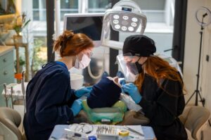 Dentists performing surgery in clinic setting