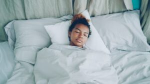 Person sleeping peacefully in a comfortable bed