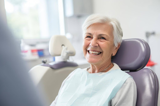 Senior patient smiling comfortably during dental examination for full mouth reconstruction near Portland, Oregon.